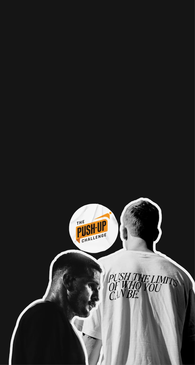 Two individuals stand against a black background. The person on the left faces forward in a black shirt, while the person on the right faces away in a white shirt with text: "Push the limits of who you can be." Above them, a logo reads "The Push-Up Challenge.