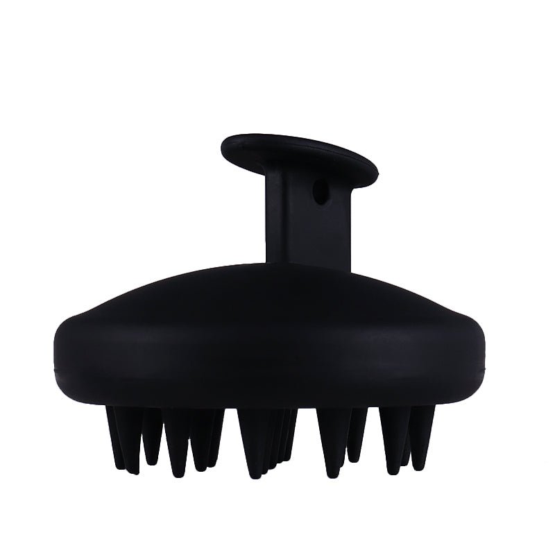 A Gro Clinics Gro Scalp Massager Brush with an ergonomic handle and multiple flexible bristles arranged beneath a rounded base. Ideal for hair care, it exfoliates the scalp gently. The handle has a hole for easy hanging or gripping.